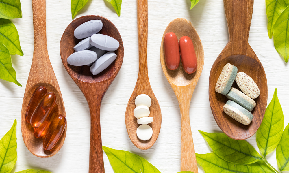 Multiple pills on wooden spoons